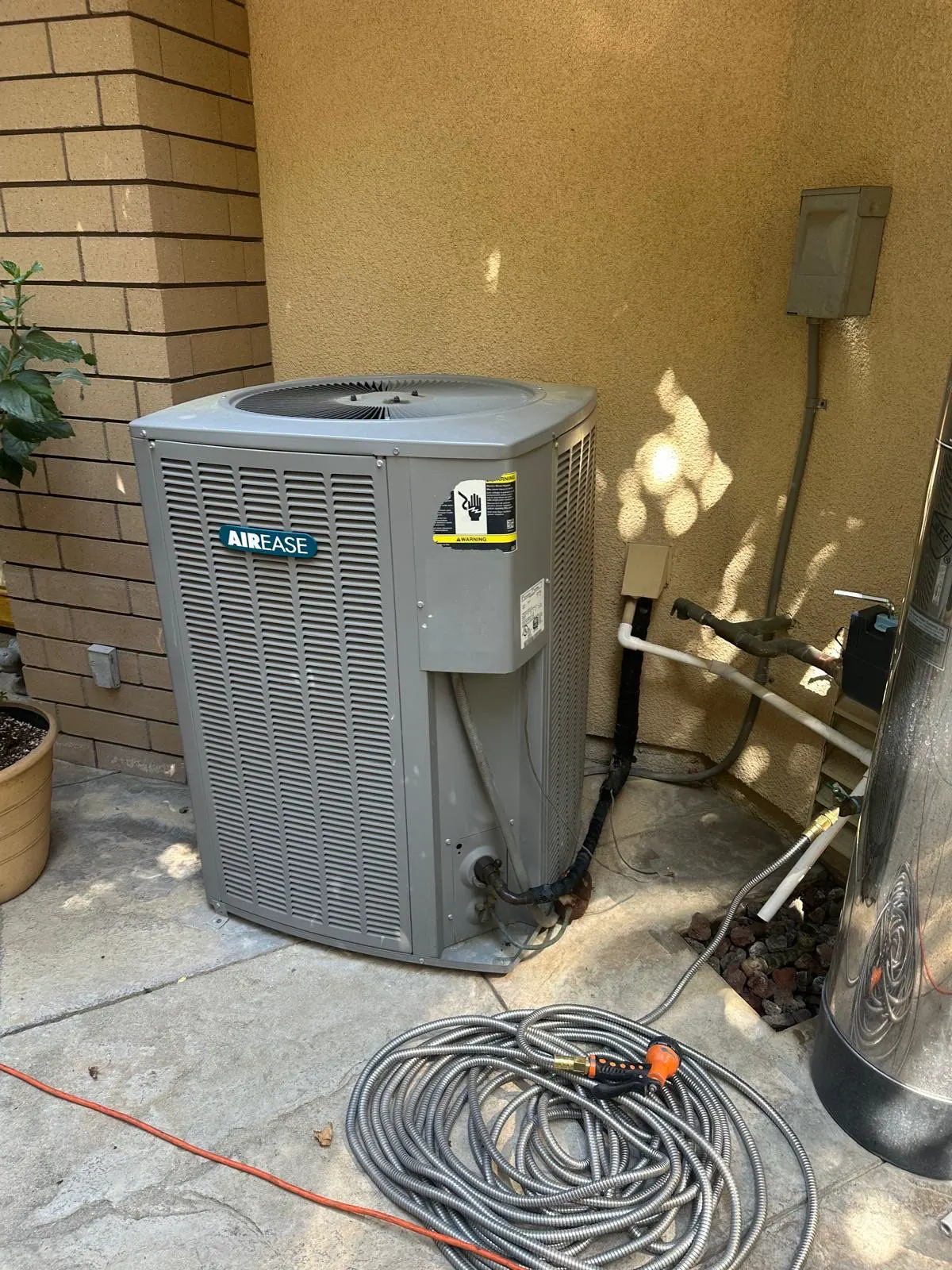 An outdoor condenser beside a house