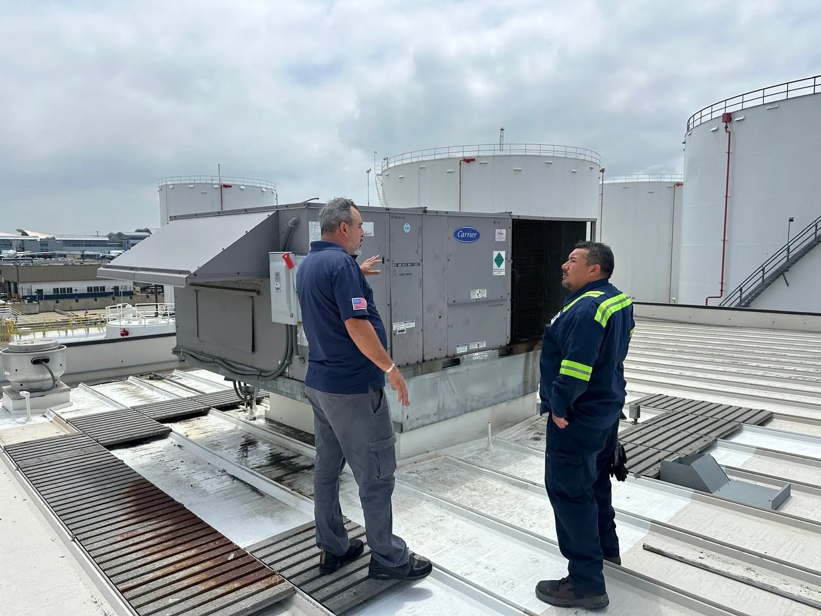 Boost technicians on a commercial roof