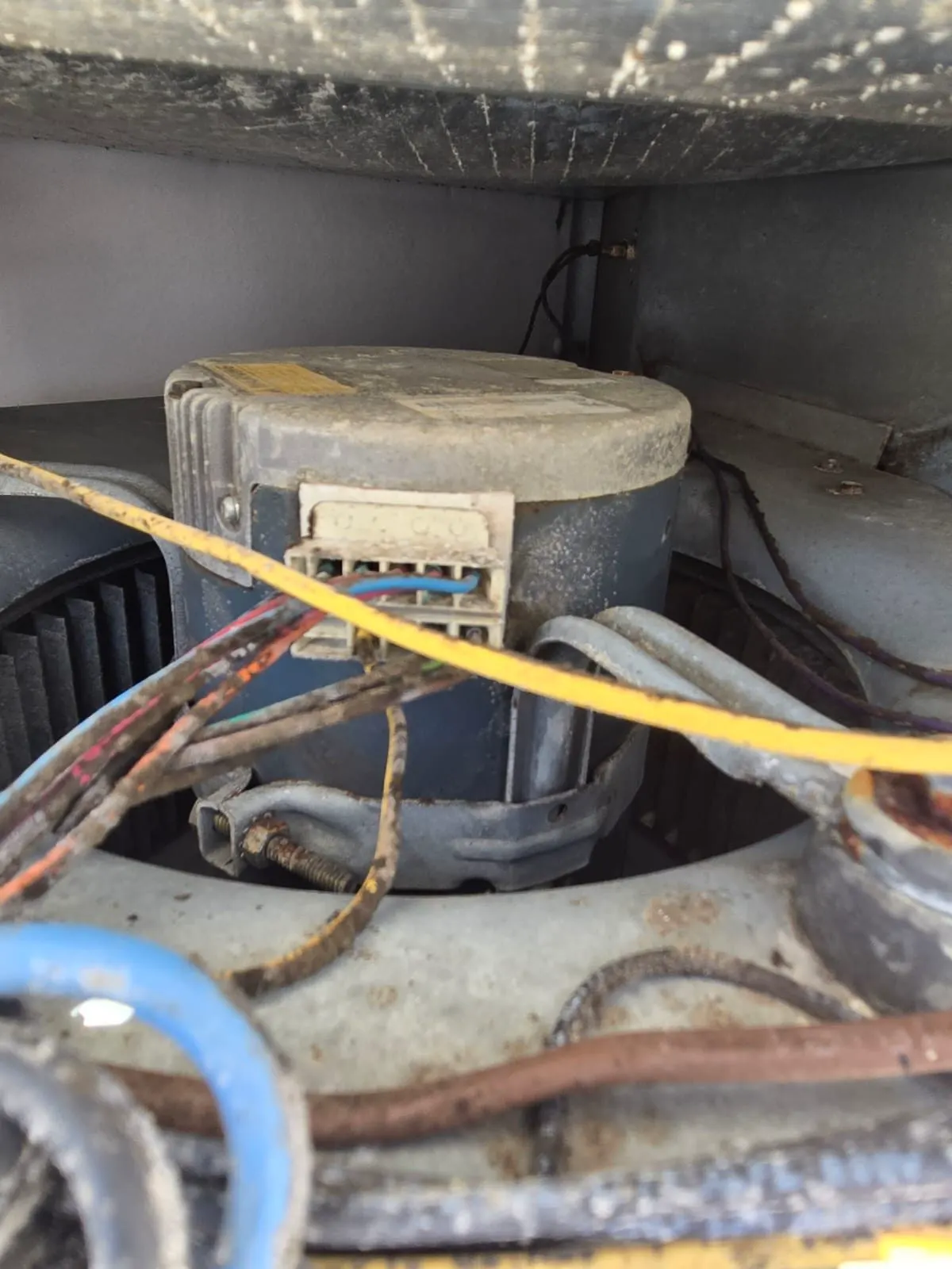 A blower motor and its wiring inside an HVAC unit