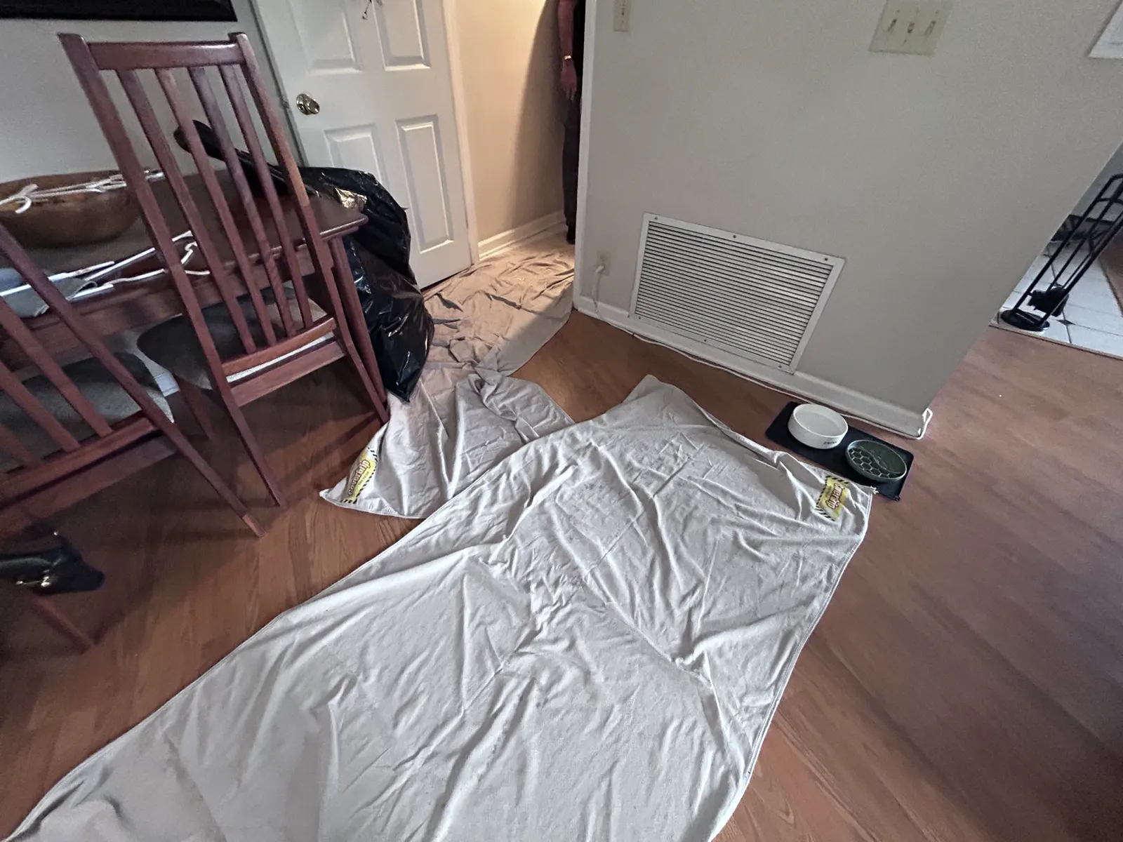 Floors covered with drop cloths before a furnace job