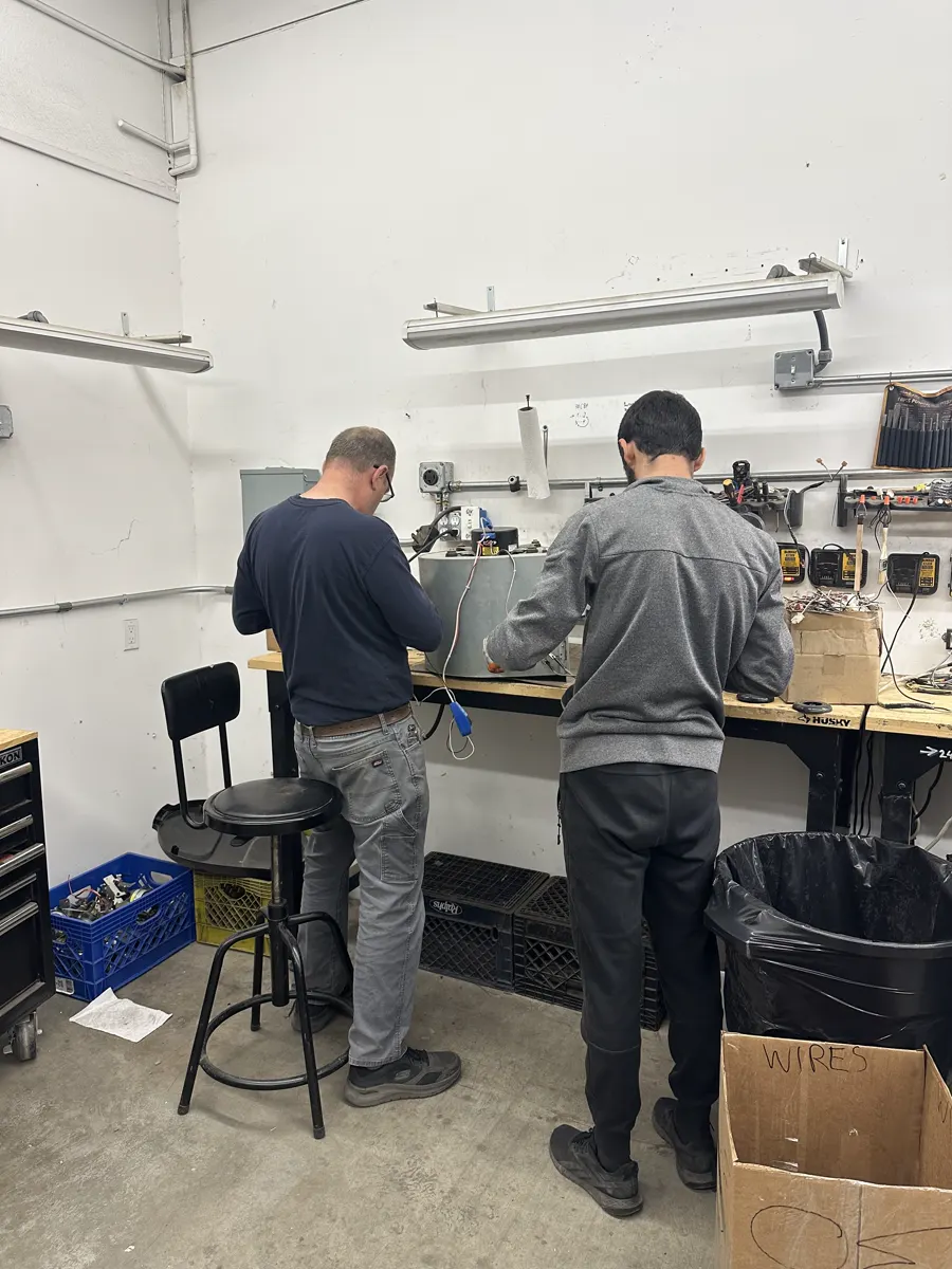 Two Boost technicians at the repair bench in our lab