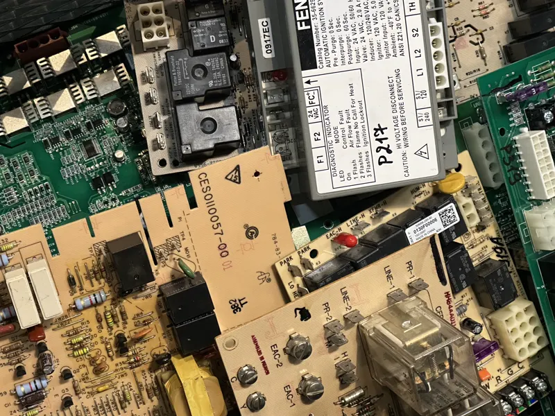 A pile of furnace control boards and an ignition control module in our lab