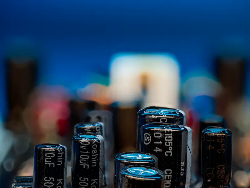 Capacitors standing on a circuit board, close up