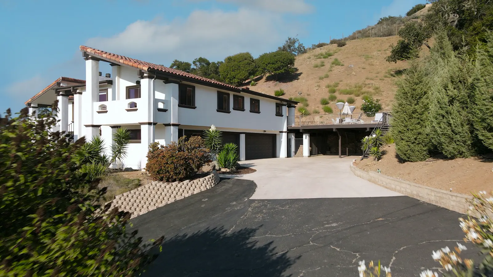 A large white house with a driveway in front of it