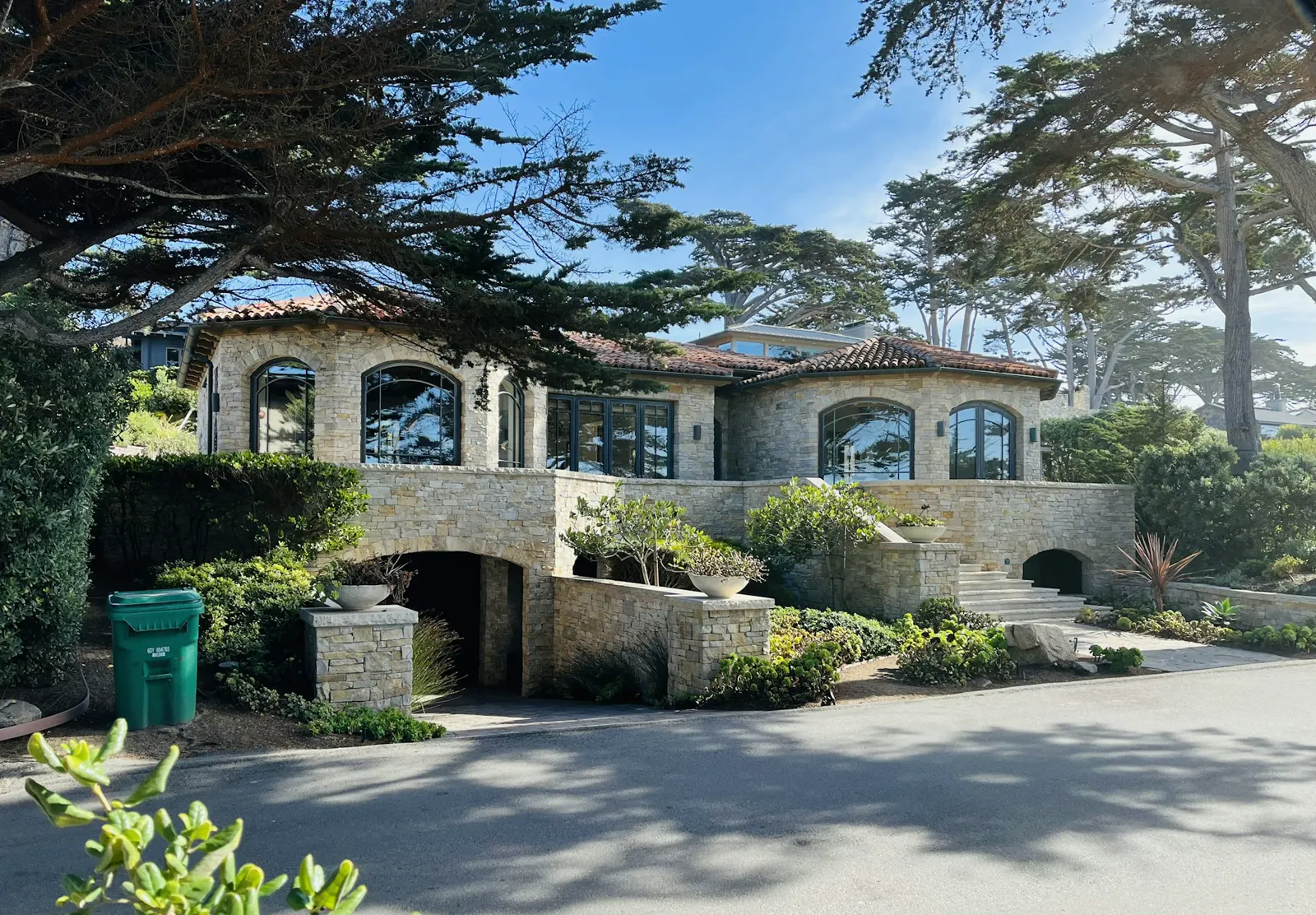 A large house with a lot of trees in front of it
