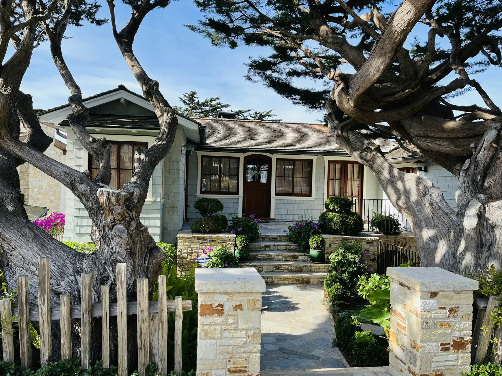 A house with a white picket fence in front of it