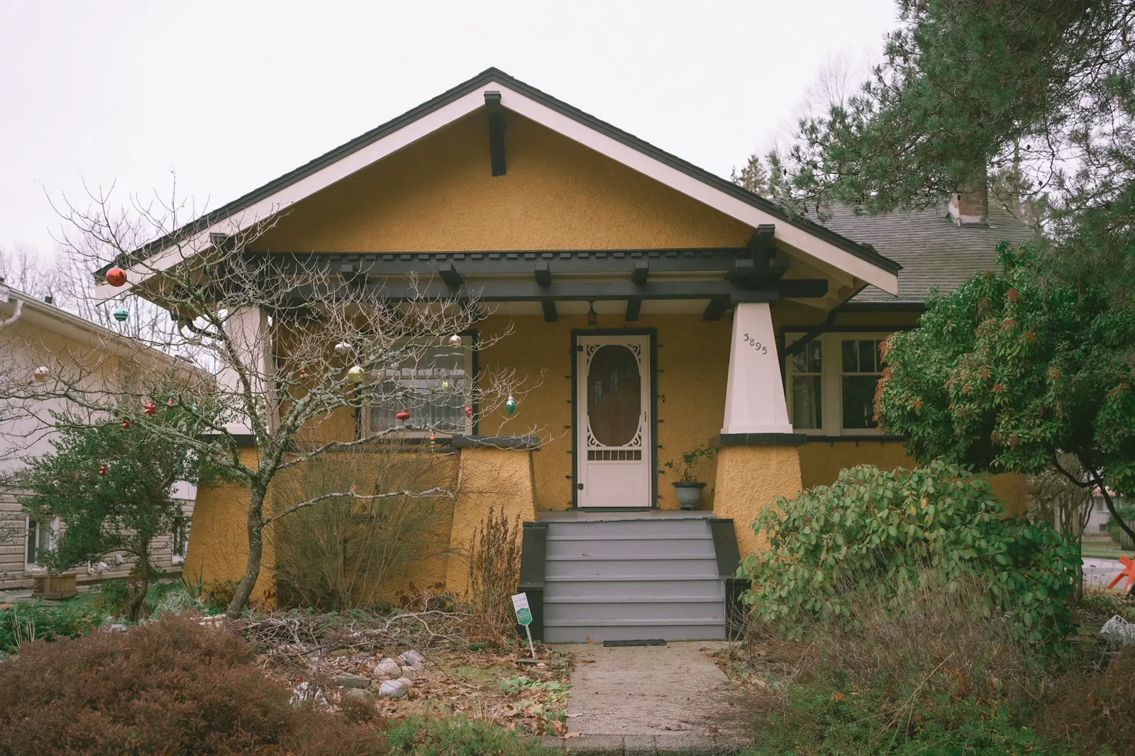 A yellow house with a white front door