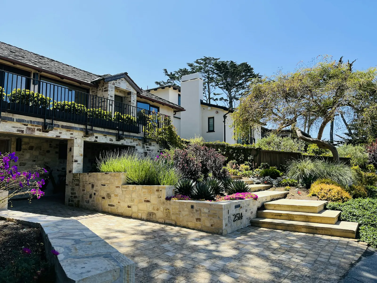 Beautiful house with stunning landscaping under a blue sky