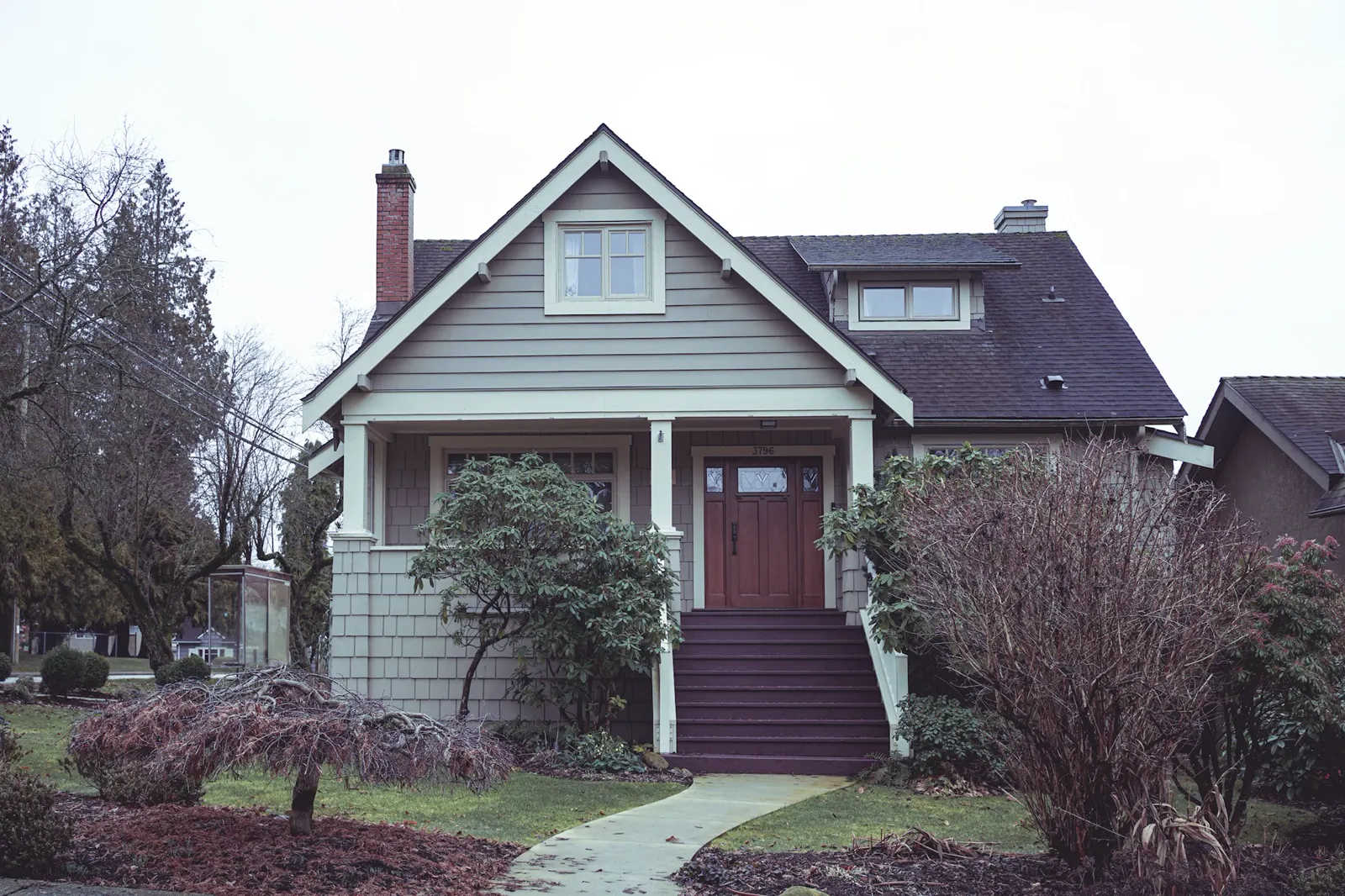 A house with a red door and steps leading to it