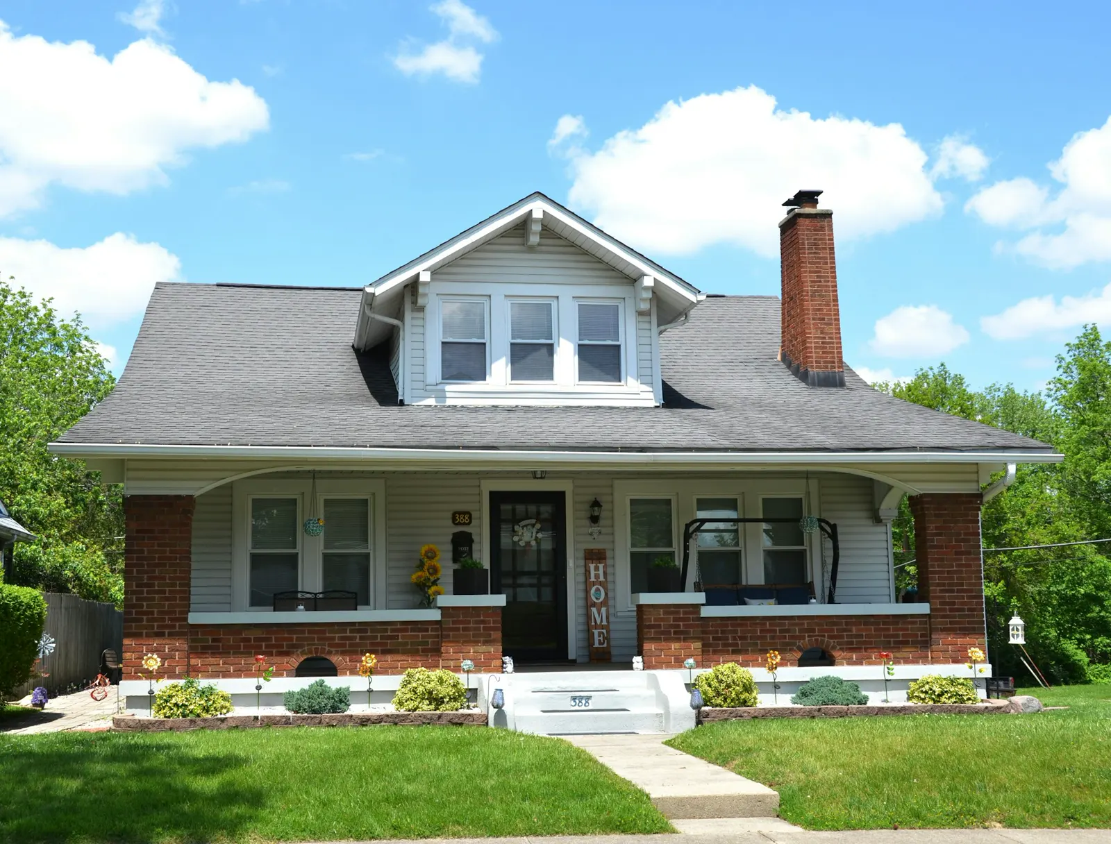 A white house with a black roof and white trim