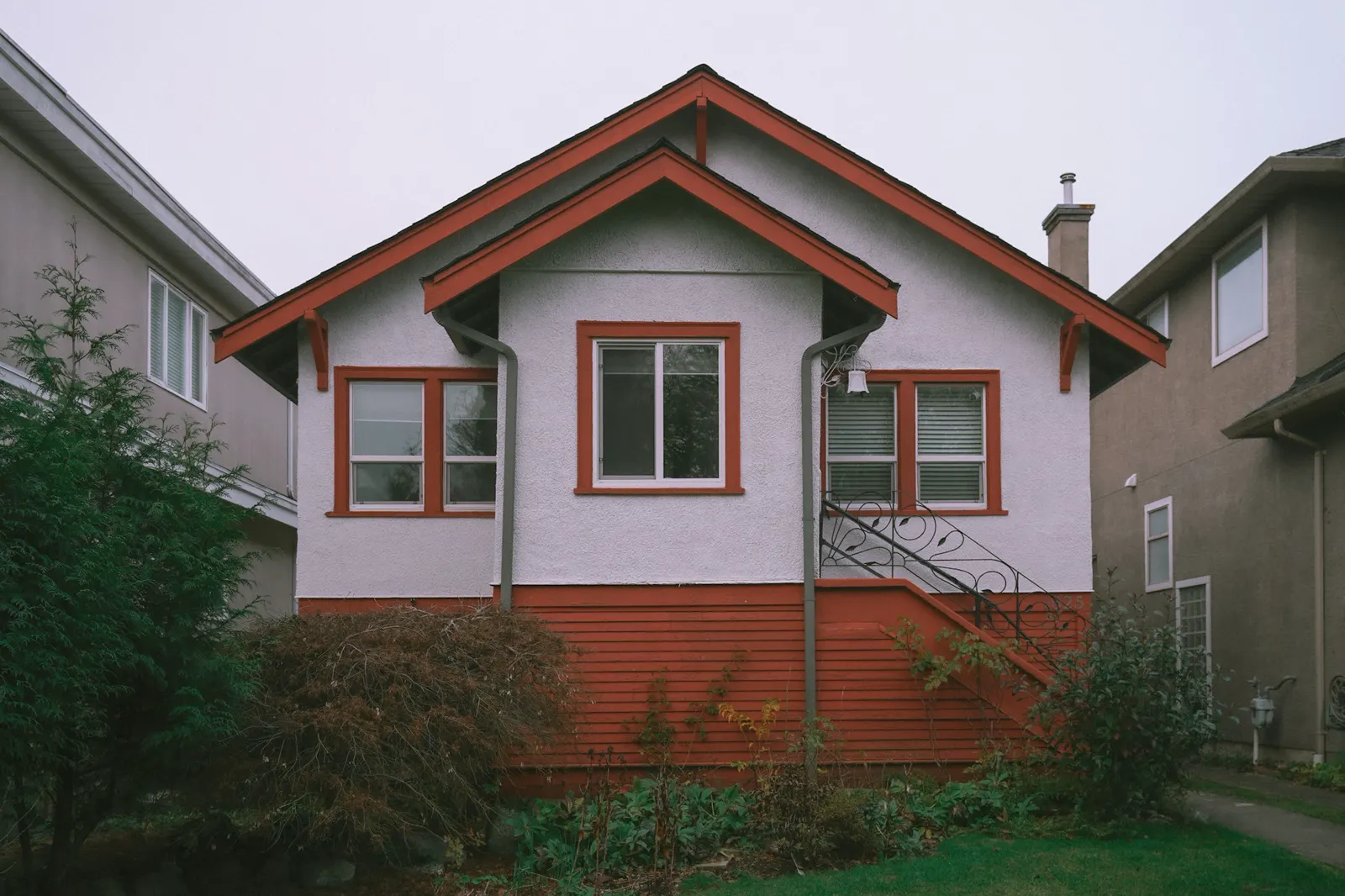 A red and white house with a red window