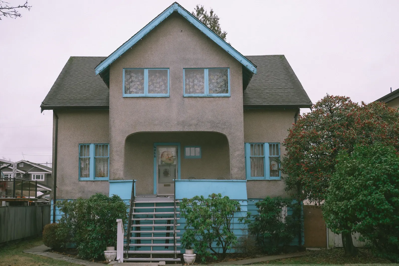 A house with a blue front door and stairs leading up to the front door