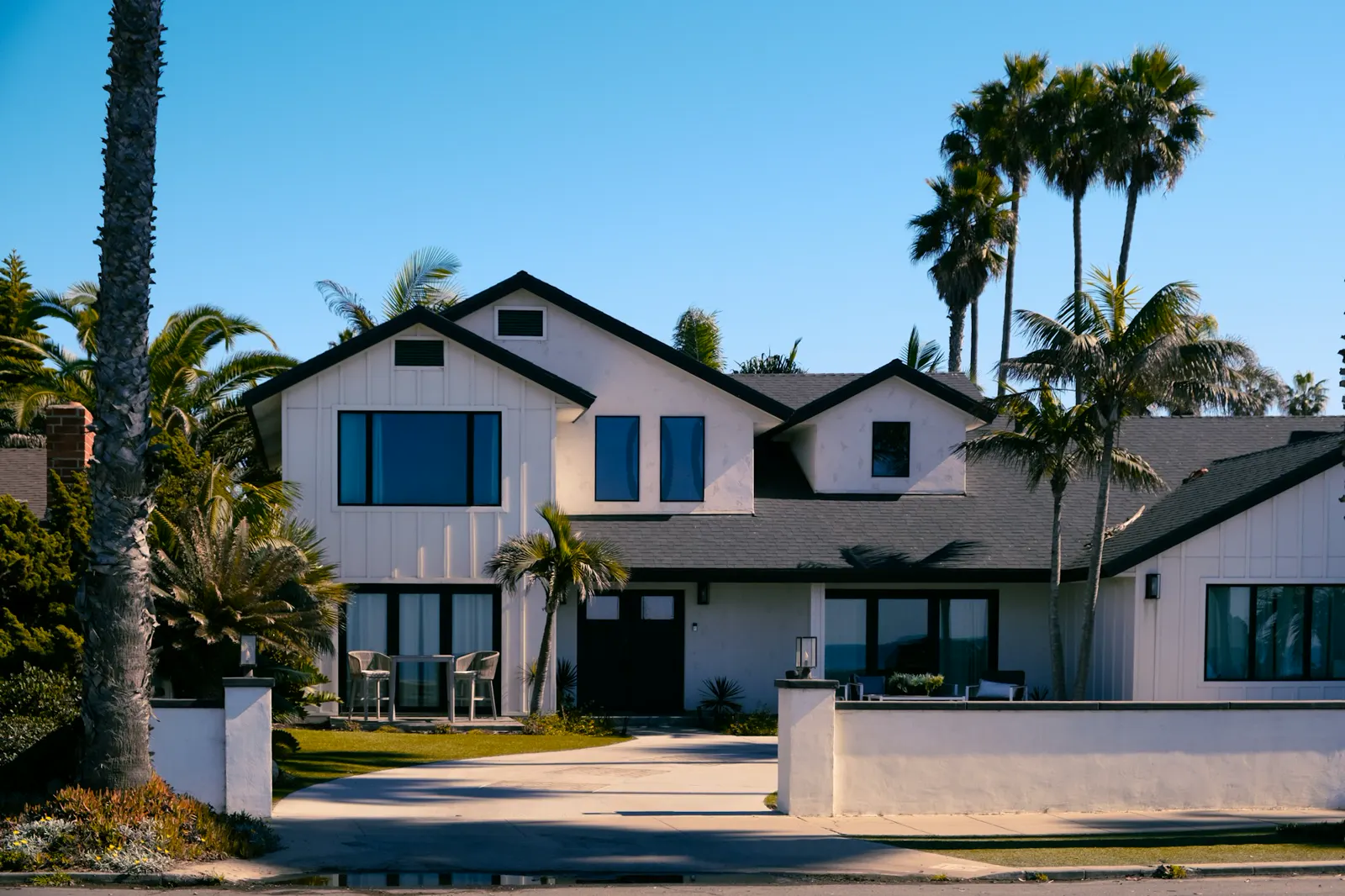 Beautiful white house with palm trees in the background