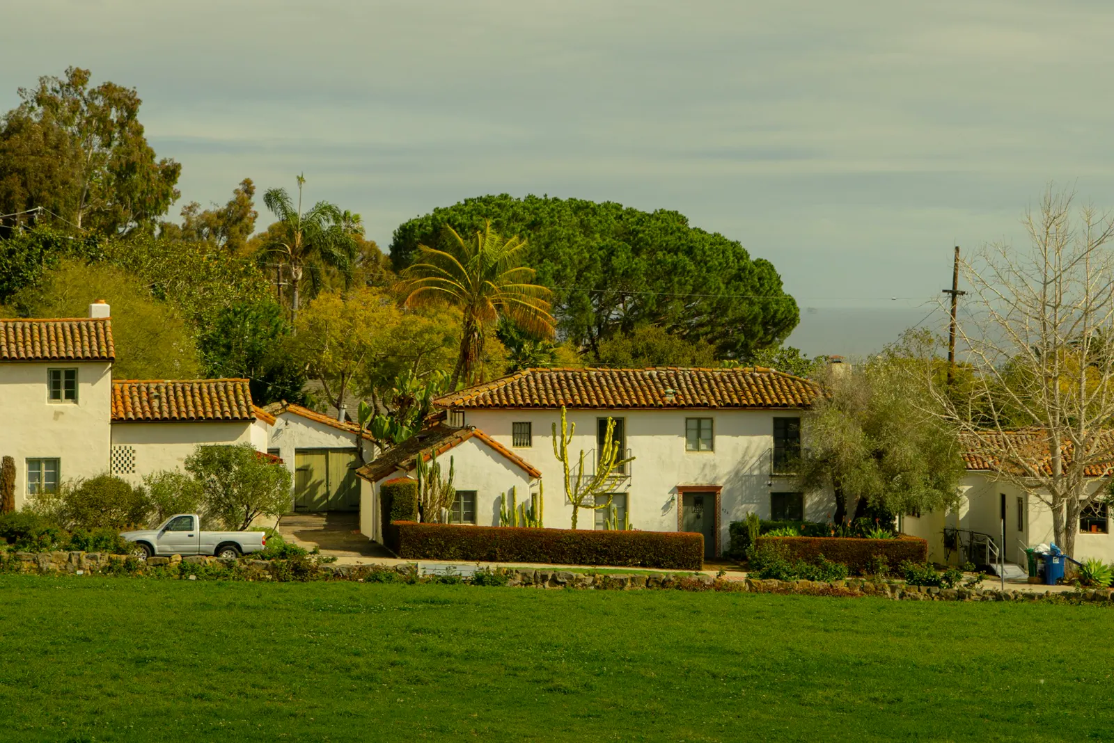 White houses with tile roofs nestled among trees