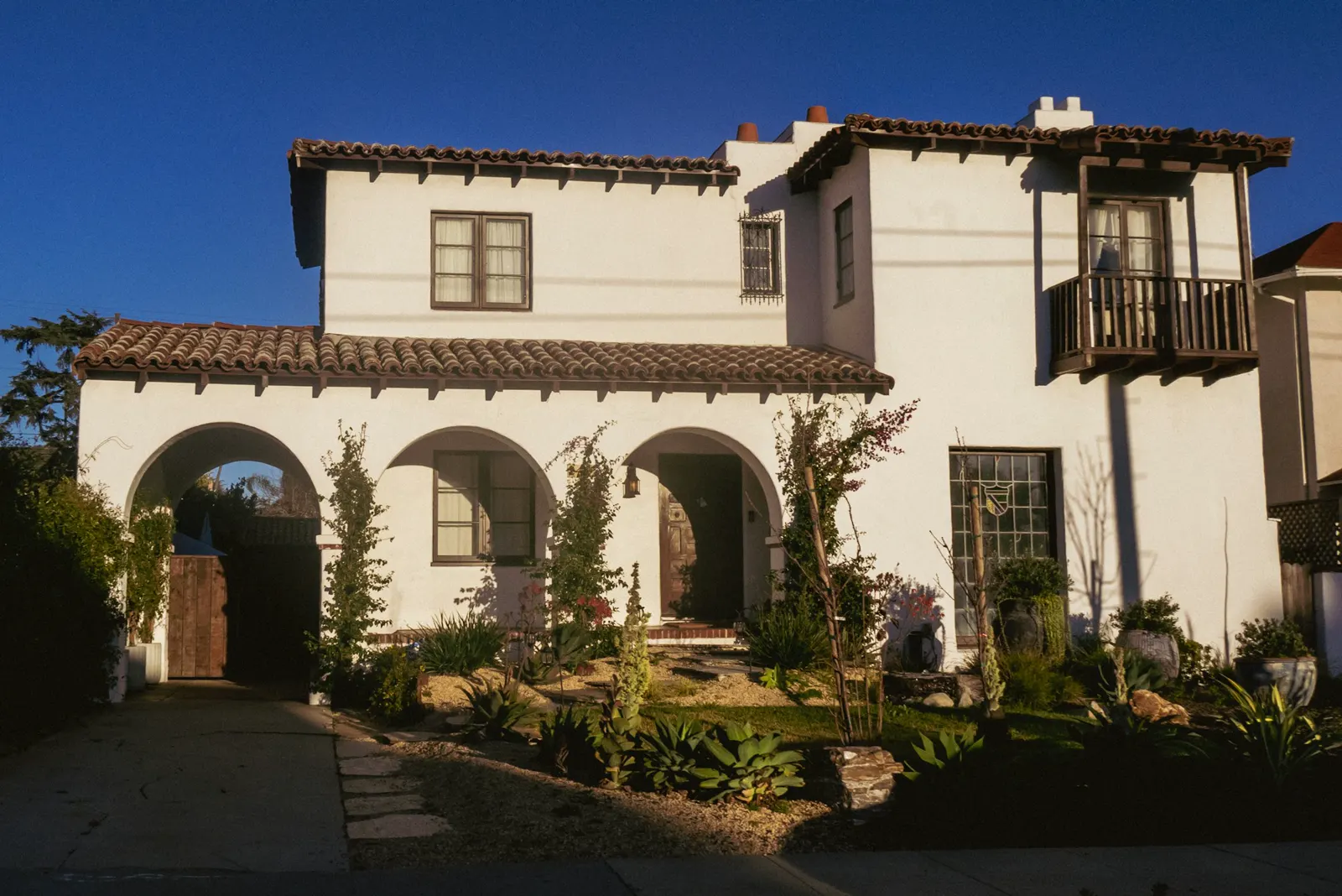 A two-storey Spanish-style home at dusk