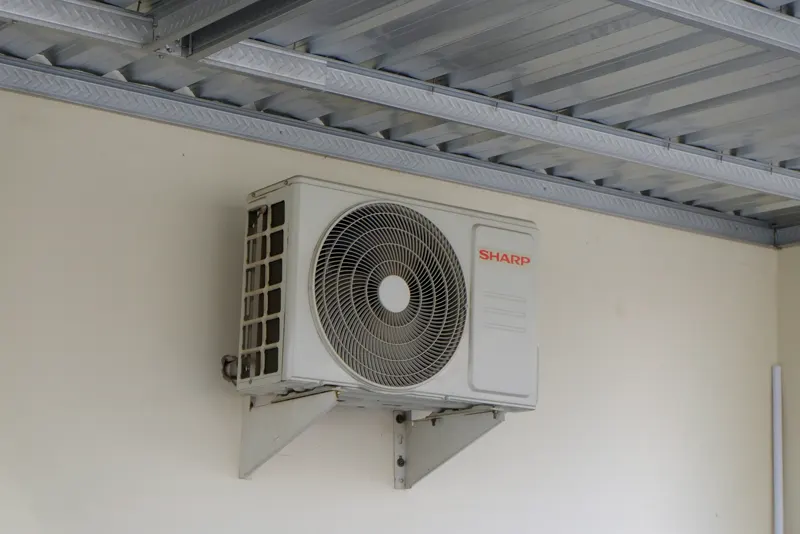 A mini split outdoor unit on an exterior wall