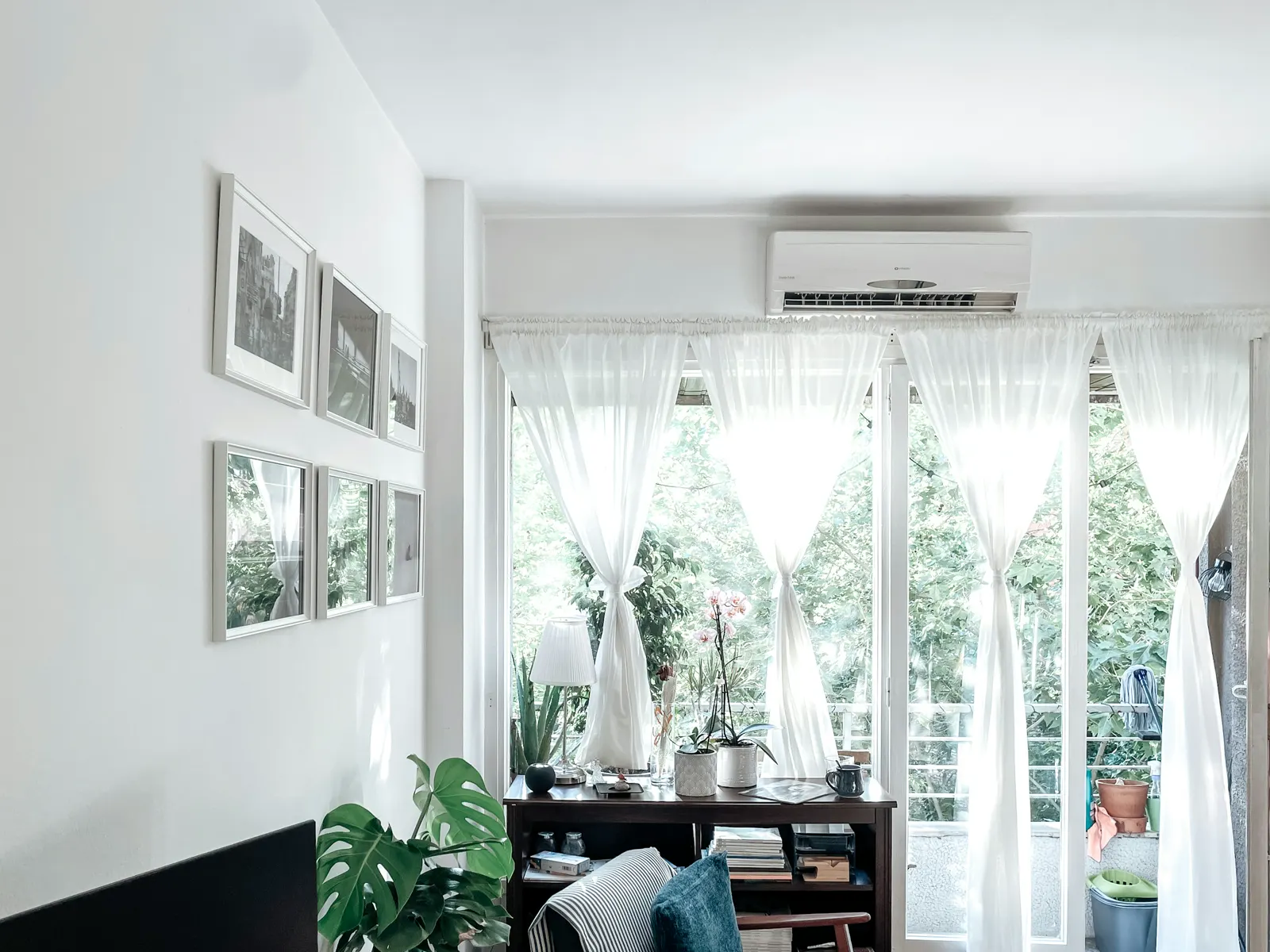 A ductless mini split head mounted above a bright window