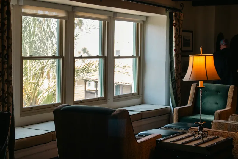A window seat with palms outside