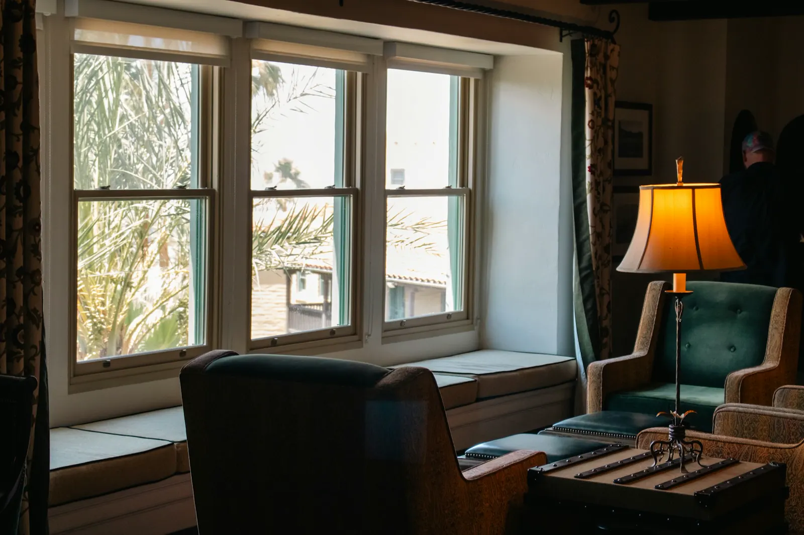 A window seat with palms outside