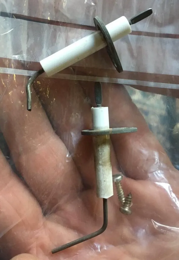 A furnace igniter and flame sensor rod pulled from a unit
